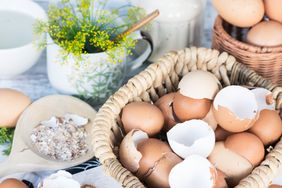 Brown and white eggshells placed in basket in home kitchen on table, eggshells stored for making natural fertilizers for growing vegetables