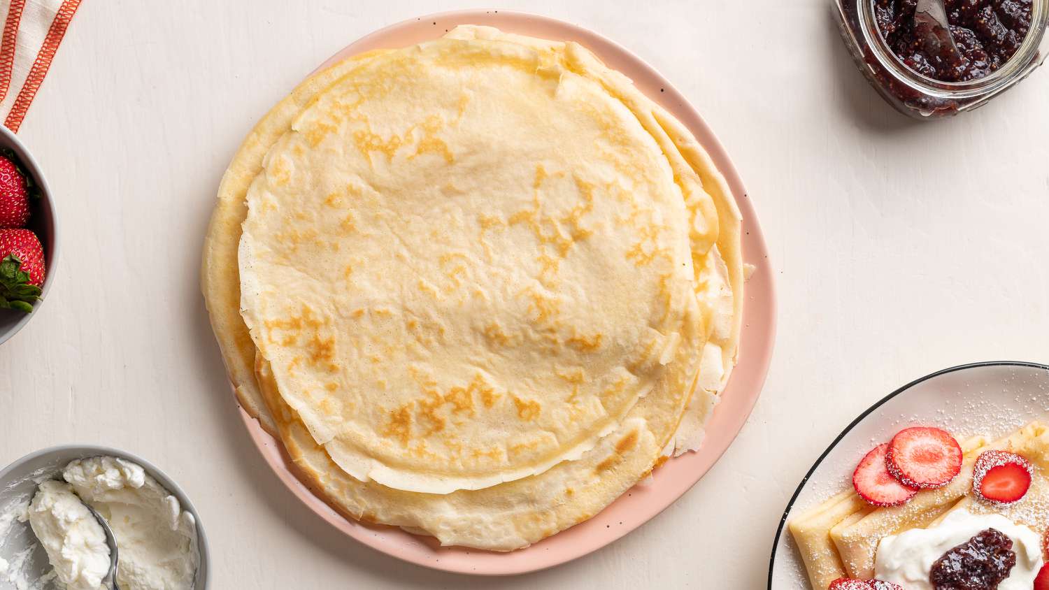 simple crepes stacked on a plate