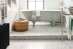 bathroom with small hexogon tile and bathtub