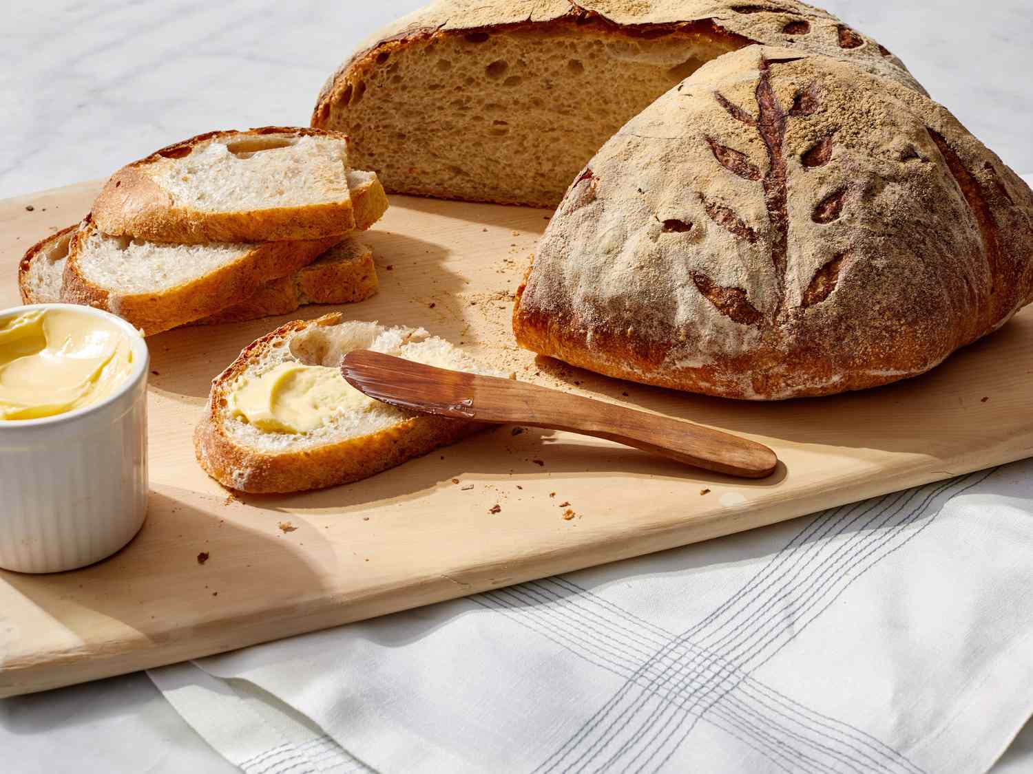 artisan boule bread martha bakes cutting board slice butter