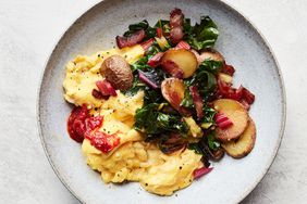 bacon potato and swiss chard scramble served on grey plate