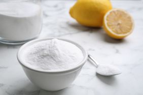 Cornstarch and cut lemons on white marble table