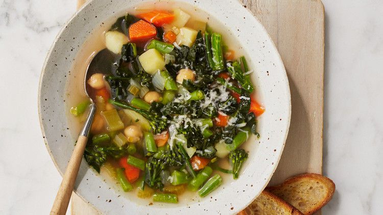 homemade vegetable soup with toasted bread on cutting board