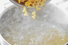 pasta going into pot of boiling water