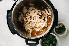 Shredded spiced chicken inside of an Instant Pot