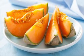 cantaloupe melon sliced on blue plate