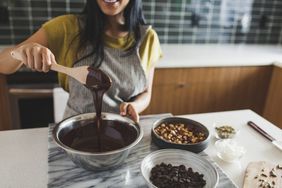 stirring chocolate sauce with wooden spoon