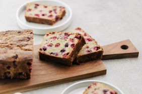 Cranberry bread sliced on a wooden board. 