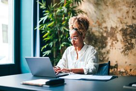 Woman working on laptop at desk