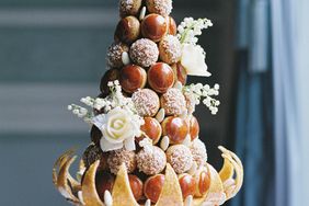 wedding croquembouche dessert adorned with white roses