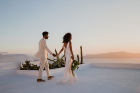 elopement outfit inspiration couple holding hands viewing sunset