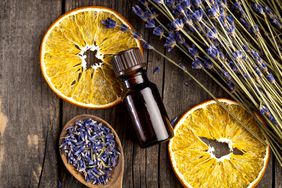 Essential oil bottle with orange slices and lavendar