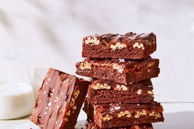 fudgy turtle brownies stacked on cutting board