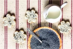 Poppy seeds in a bowl and on cookies