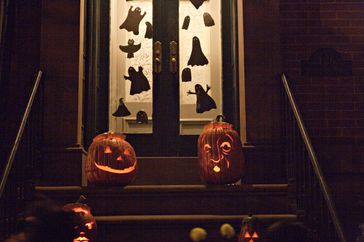 Carved Halloween pumpkins on a stoop. 