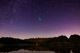 Comet C/2021 A1 Leonard at dawn over the river.