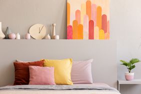 Colorful bedroom with painting and a plant