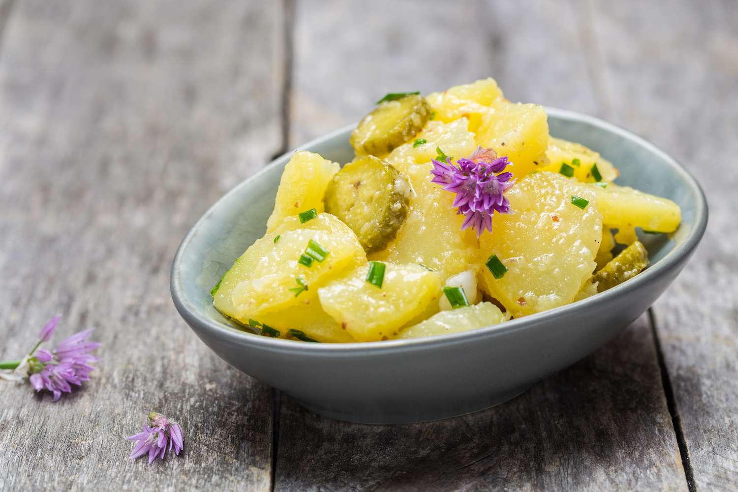 potato salad with purple edible chive blossoms