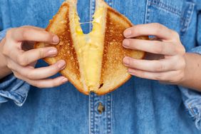 hands holding grilled cheese