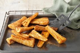 Honey roast parsnips on baking tray with green cloth