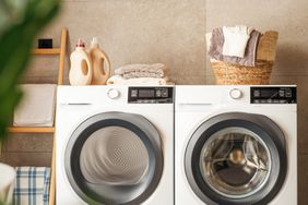 Interior of a real laundry room with a washing and drying machine at home