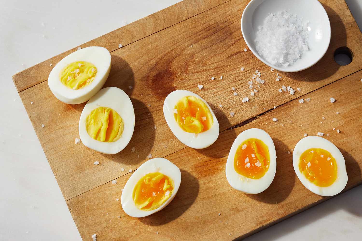 hard boiled eggs on wooden board