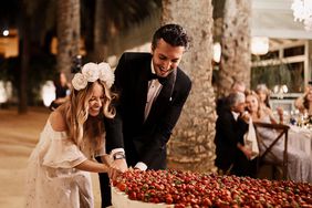 karolina sorab wedding bride groom cutting cake with strawberries