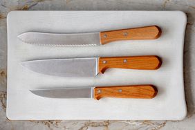 Three kitchen knives on cutting board