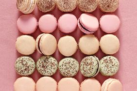 variety of french macarons on pink background