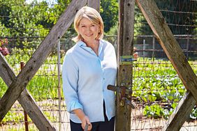 martha with a basket of lettuce garden gate