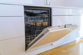 Modern domestic cabinets with new appliances dishwasher in kitchen