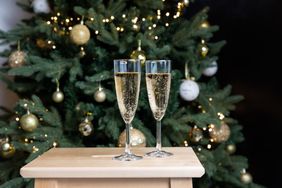 Glasses with champagne on the background of christmas decorations. 