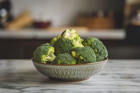 broccoli in a bowl on a marble background