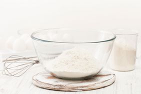 Flour in glass bowl with whisk