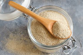 raw uncooked fonio in jar with spoon 