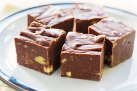 Homemade fudge with nuts and arranged on a small plate.