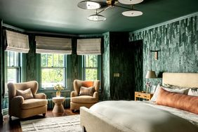 deep green bedroom with wallpaper and painted ceiling