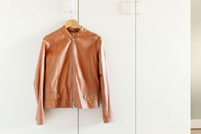 Leather jacket hanging from wardrobe