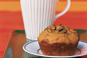 pumpkin seed muffin on a plate with white mug