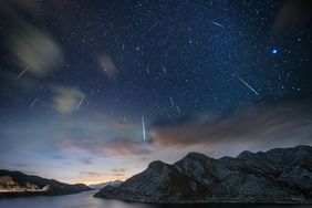 Meteor shower over mountains and water