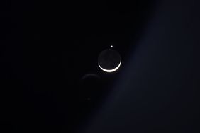 The Moon and Venus shining brightly in the night sky.