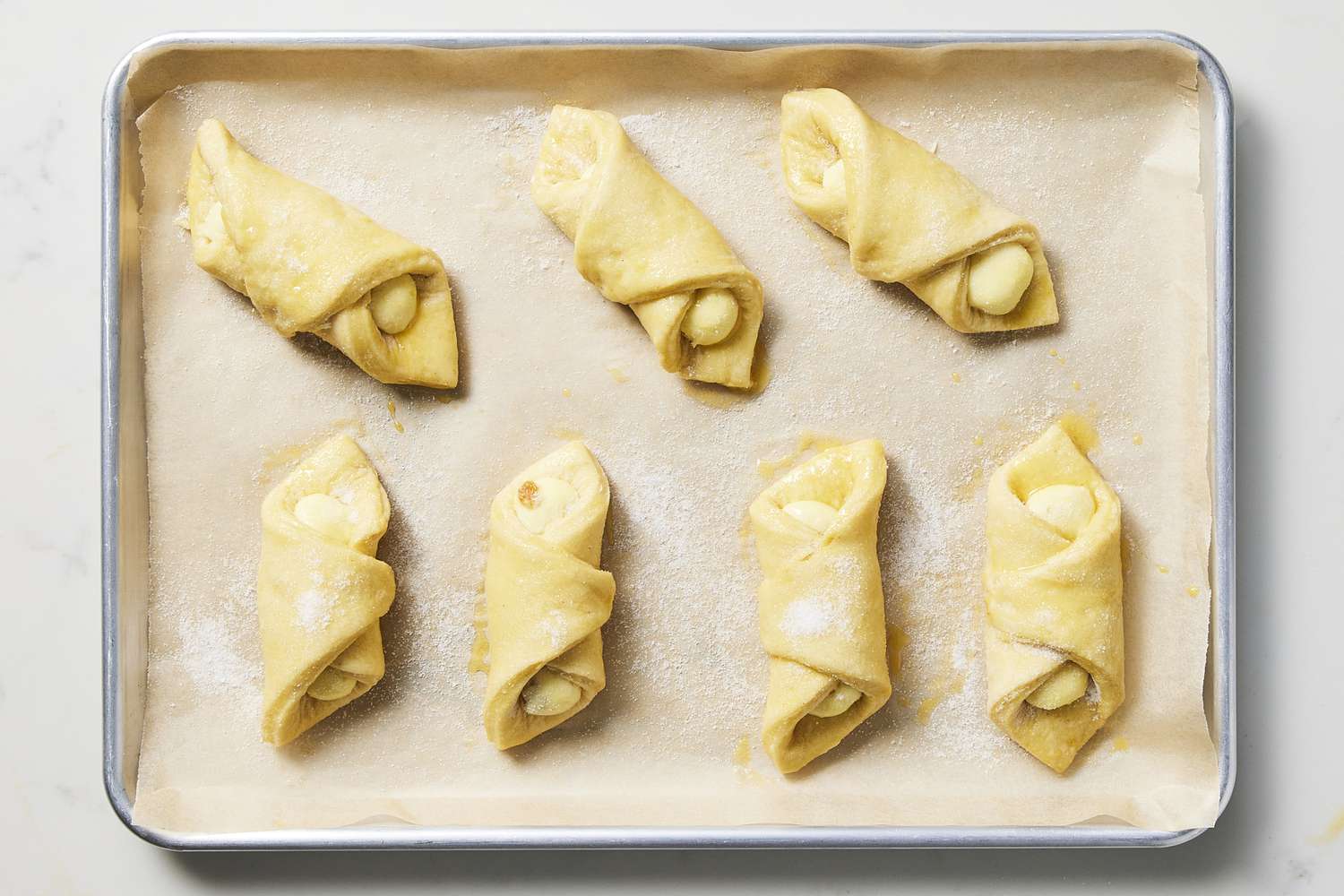 Resting cheese danishes on baking sheet lined with parchment paper 