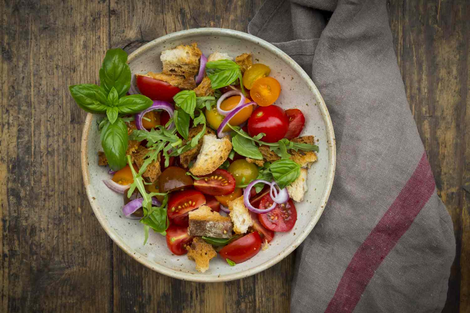 Panzanella made of roasted Ciabatta, rocket, red onions, tomatoes and basil