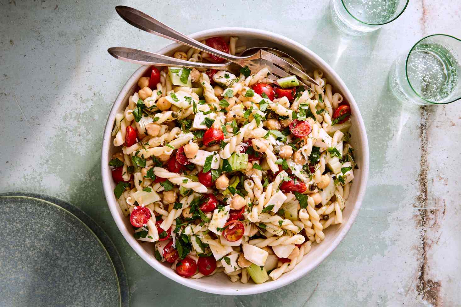 tomato mozzarella pasta salad in white bowl