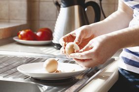 Peeling hard boiled eggs by window