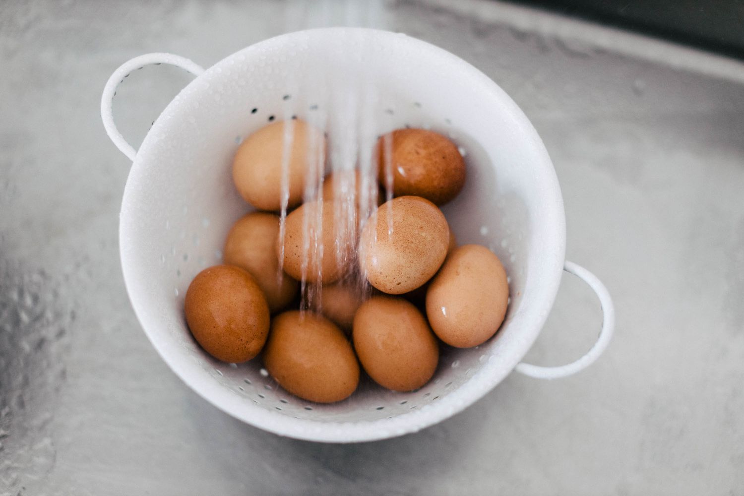 eggs under running water for perfect hard-boiled eggs recipe