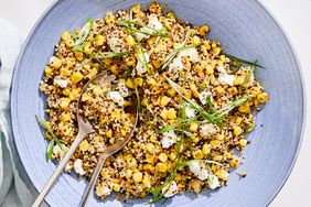 quinoa with caramelized corn and scallions served in a blue bowl