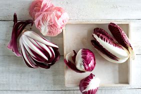 overhead view of multiple types of radicchio on white wood surface