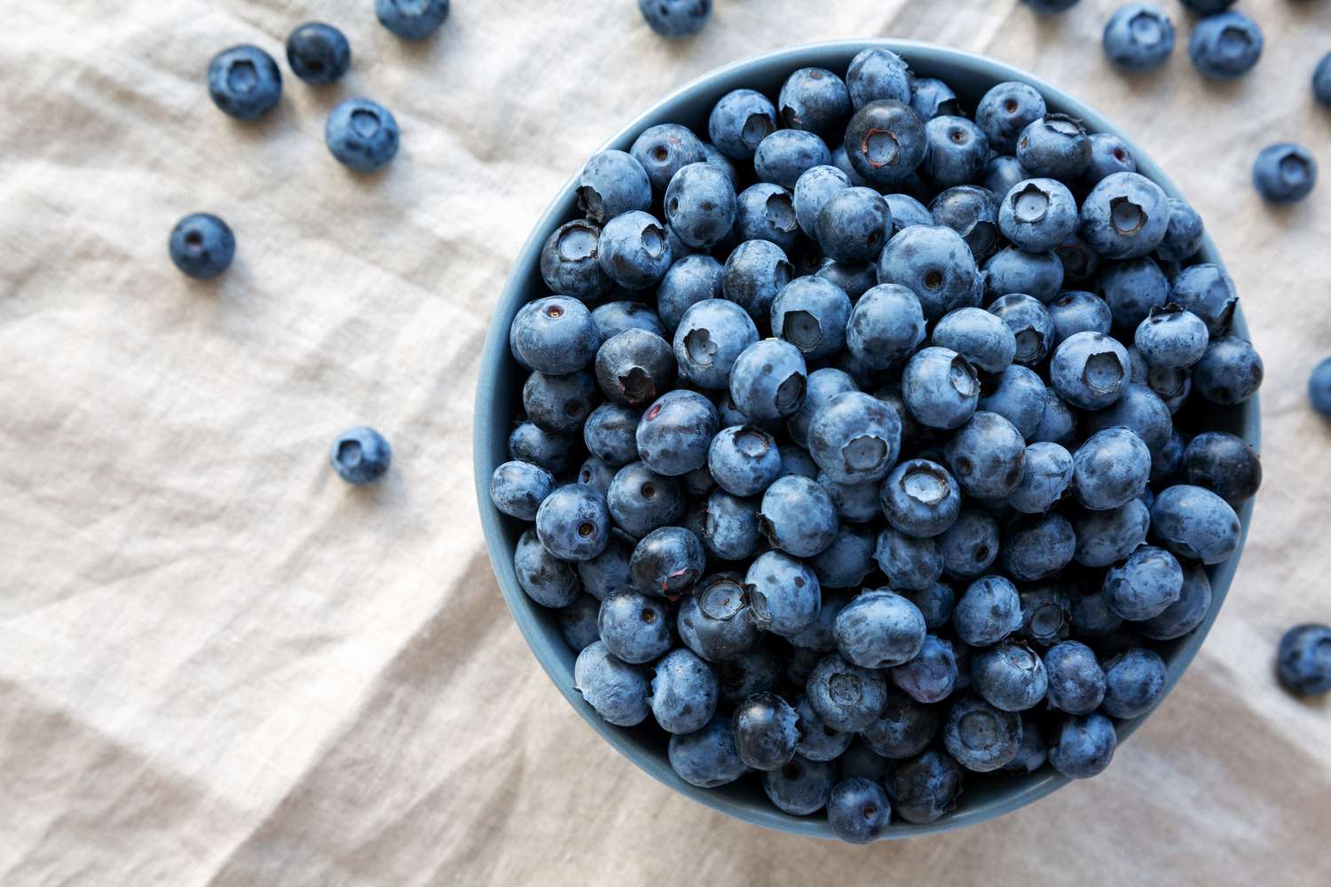 Raw Organic Blueberries in a Bowl, top view. Flat lay, overhead, from above.