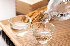 Cold sake with rice and ear of rice on the table